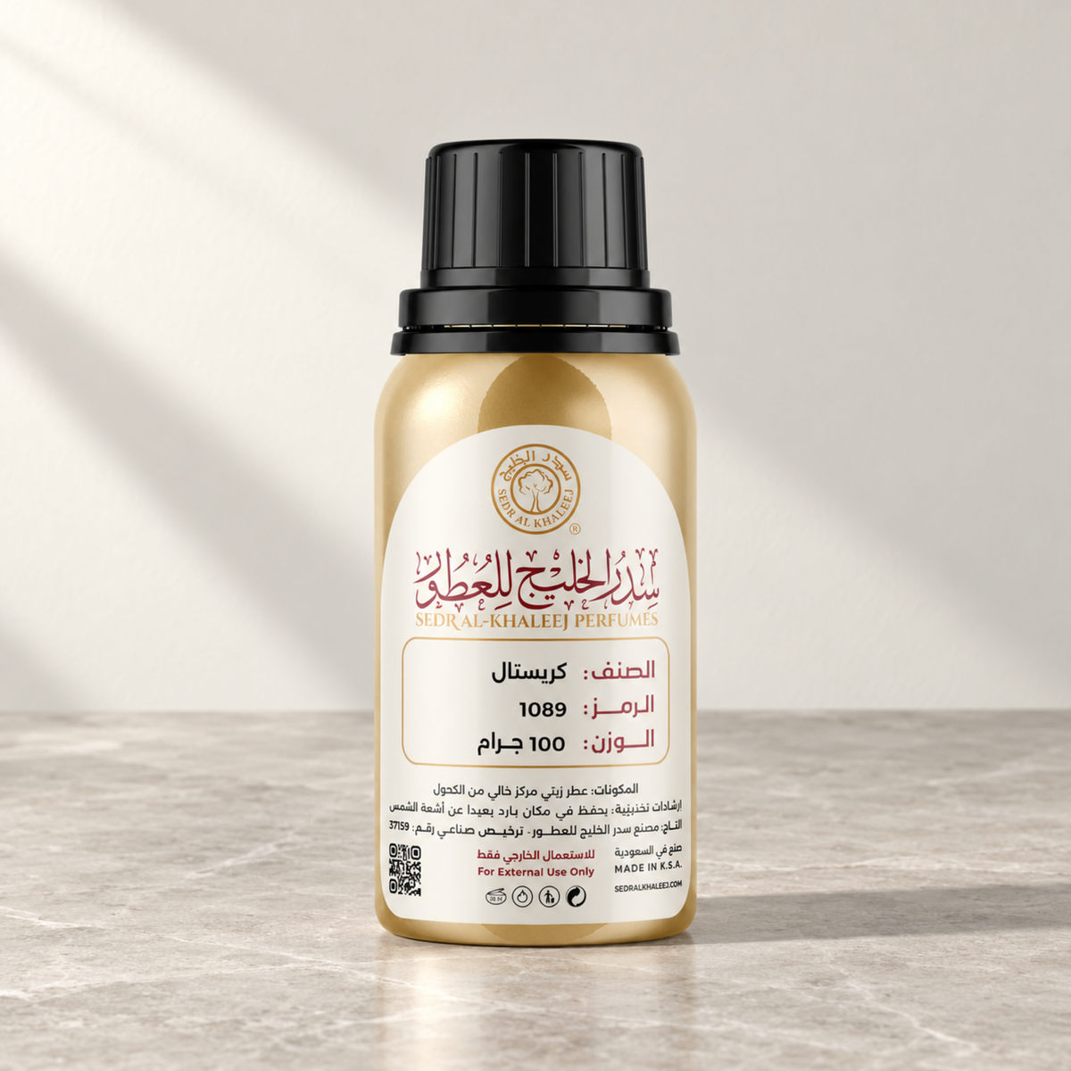 Sedr Al-Khaleej crystal perfume oil; one closed original bottle on honed oyster-grey marble without busy veins before a cool ivory, soft oyster backdrop.