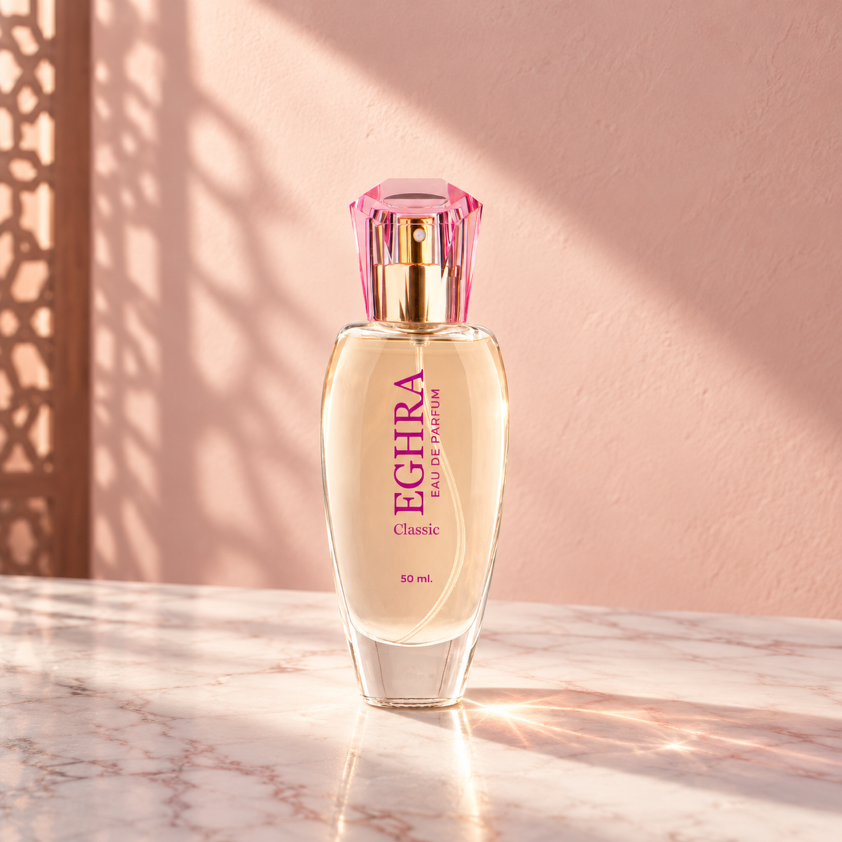 Eghra Classic 50 ml perfume bottle with a pink cap on white marble against a blush wall in sunlight.