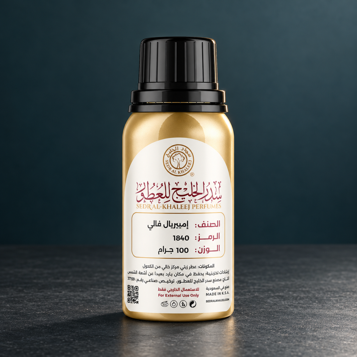 Sedr Al-Khaleej imperial valley perfume oil gold bottle on dark grey honed basalt, against plain deep teal-grey wall