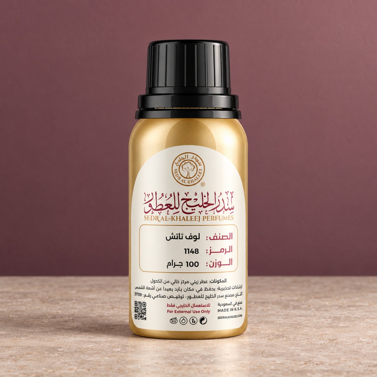 Sedr Al-Khaleej love touch perfume oil; one closed original bottle on light taupe honed limestone, against plain muted warm plum-rose wall.