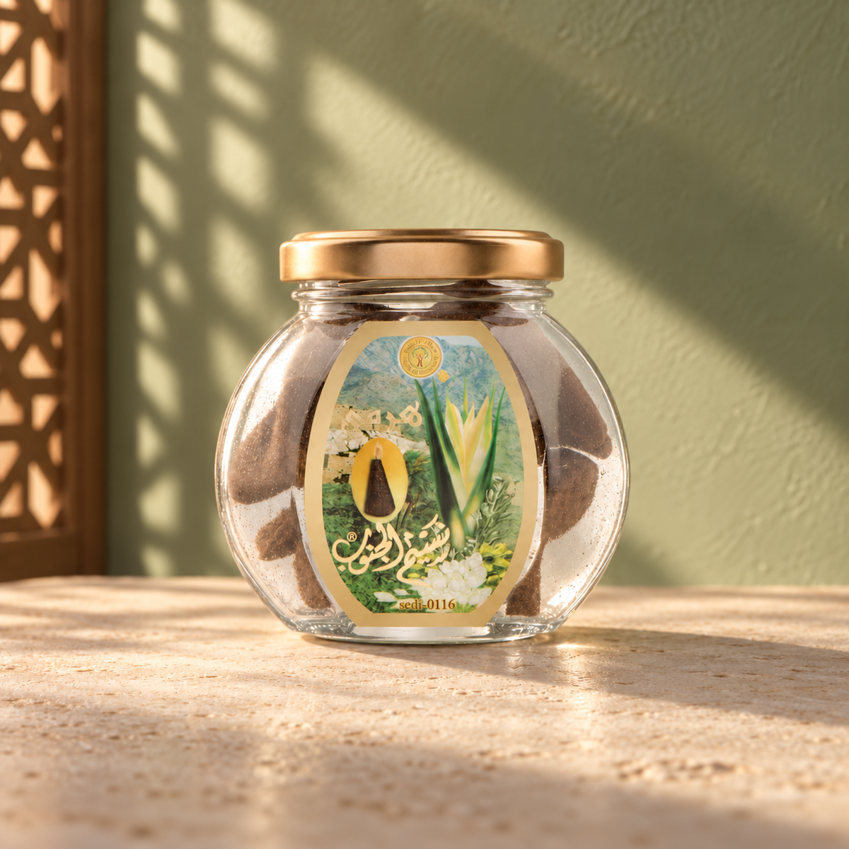 Naseem Aljanob Pyramid Maamoul 50 g from Sedr Al-Khaleej; round glass incense jar with a green label and gold lid on limestone against a sage-green wall.