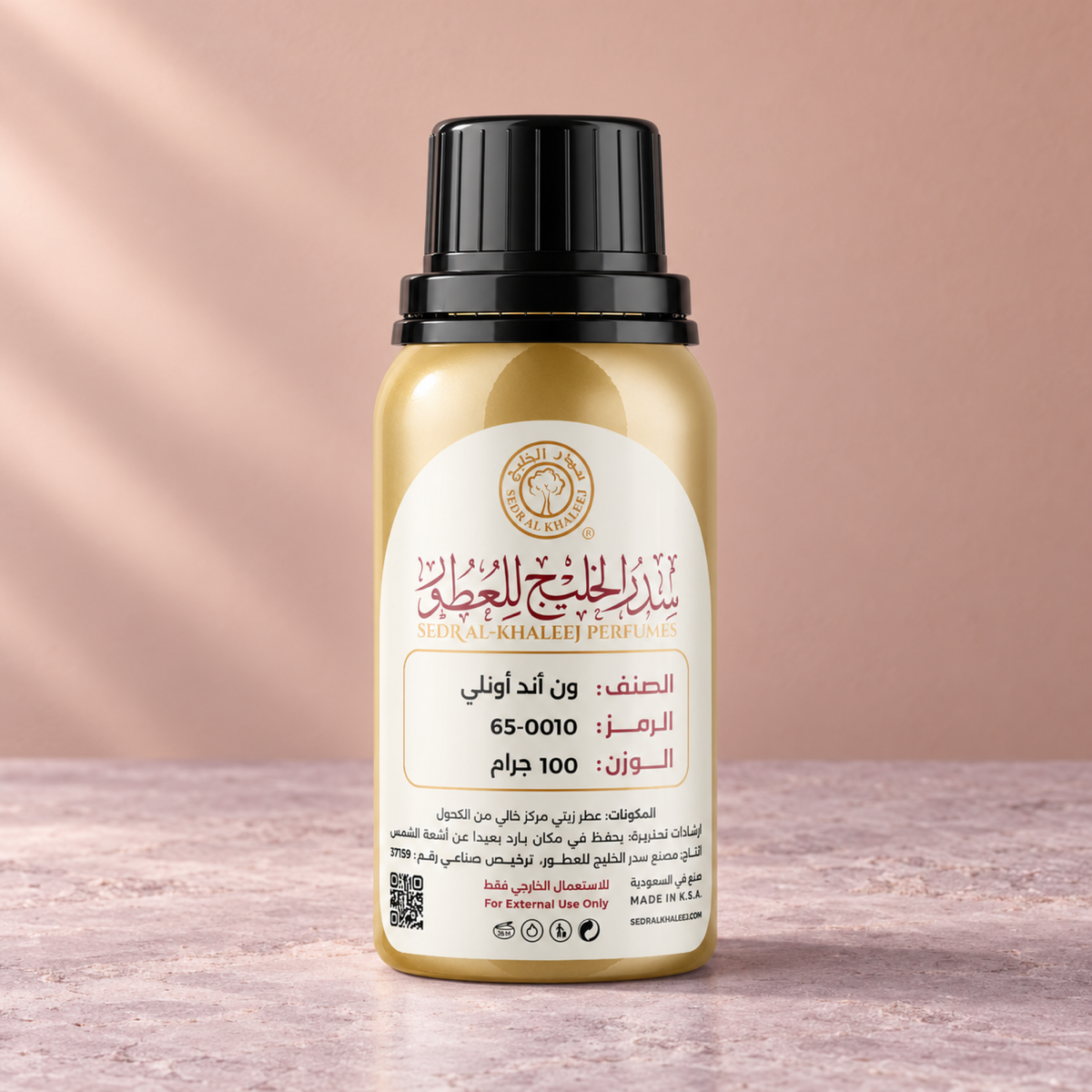 Sedr Al-Khaleej one and only perfume oil; one closed original bottle on pale mauve mineral stone before a dusty peach, soft mauve backdrop.