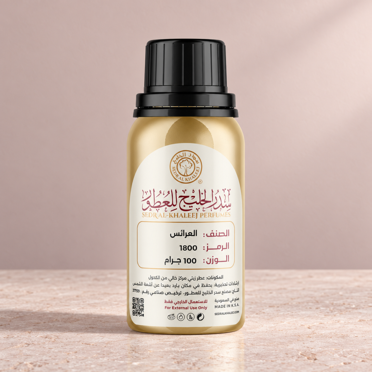 Sedr Al-Khaleej Al Araaes perfume oil, gold bottle on pale pink limestone against a powder blush backdrop in soft daylight