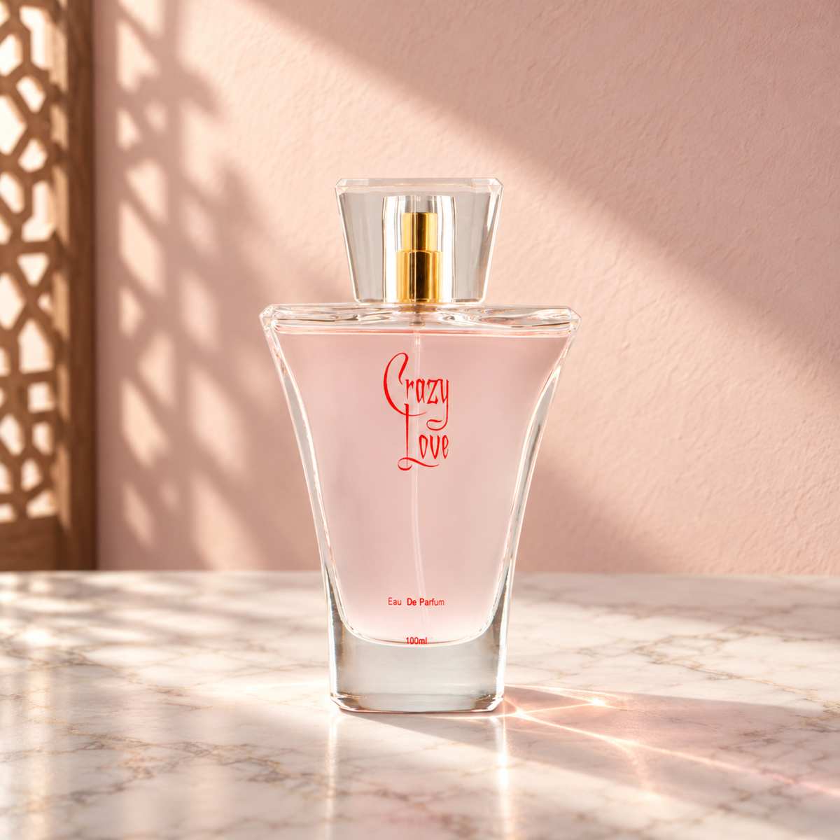 Crazy Love glass perfume bottle on white marble against a pale blush wall, lit by angled sunlight with a wooden screen shadow on the left.
