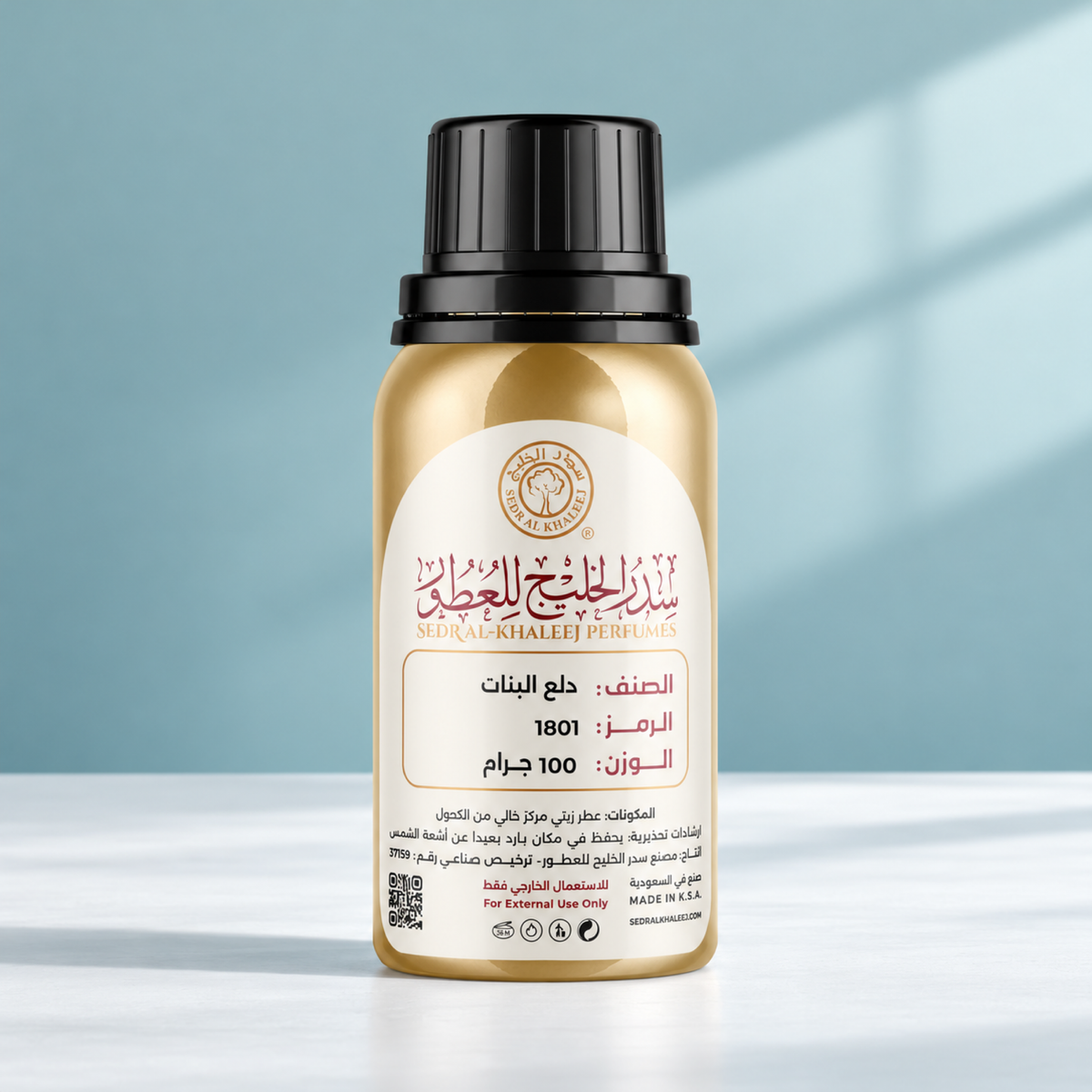 Sedr Al-Khaleej dalaa al bnaat perfume oil; one closed original bottle on matte cool-white porcelain before a mist blue-green, cool white backdrop.