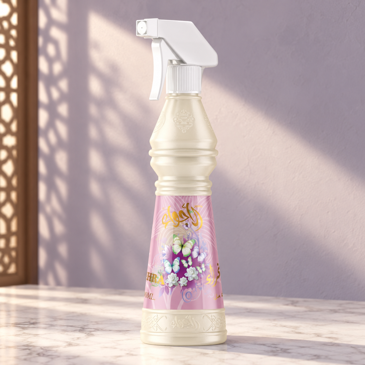 Eghra Air Freshener 500 ml from Sedr Al-Khaleej; spray bottle with a white trigger and pink label on marble against a pale lilac sunlit wall.