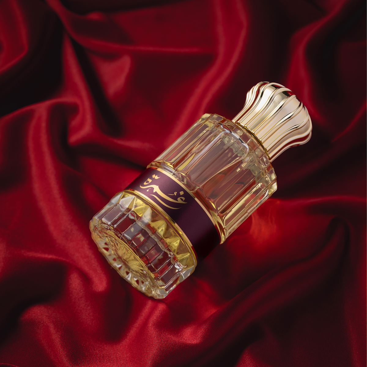 Ghumra perfume bottle on red fabric