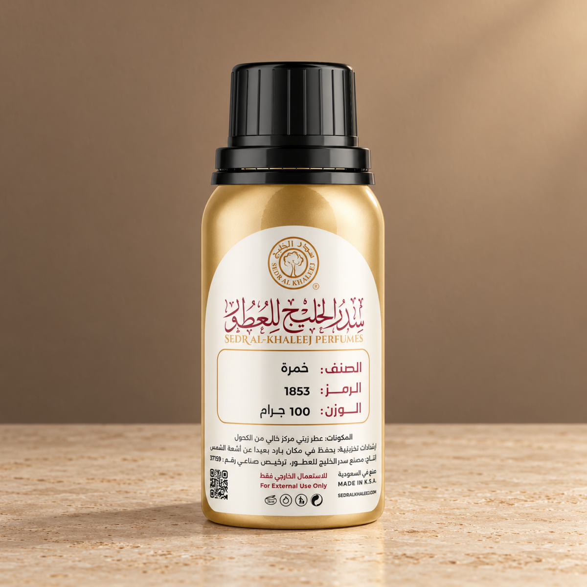 Sedr Al-Khaleej khamrah perfume oil; one closed original bottle on cream honed travertine before a soft toffee beige and cocoa backdrop.