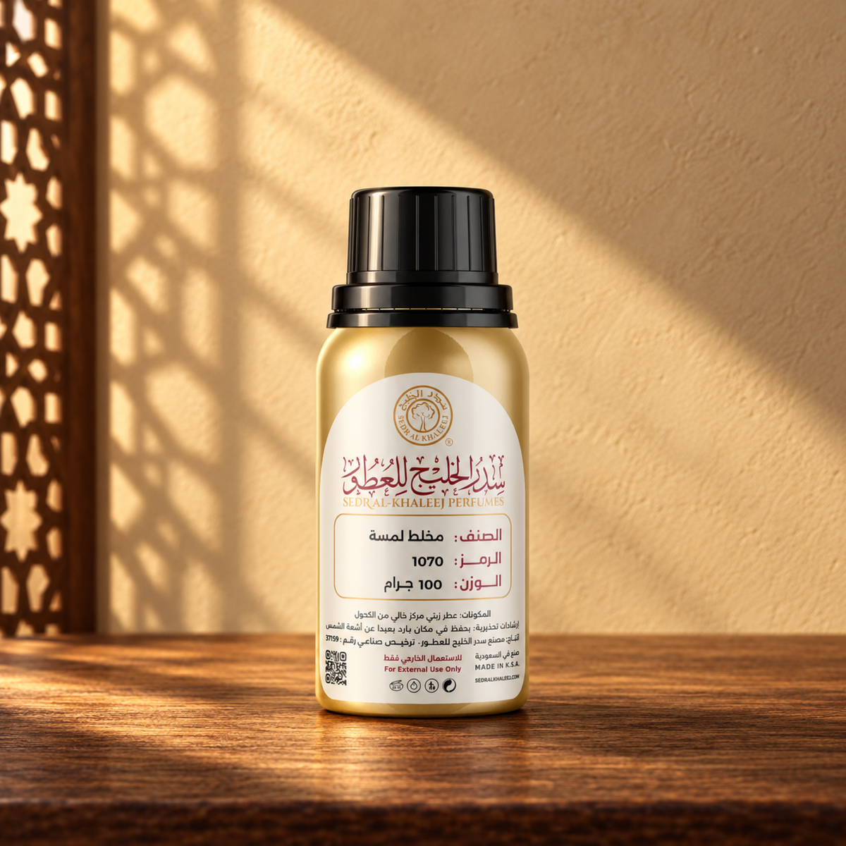 Sedr Al-Khaleej Lammsah Perfume Oil bottle on a walnut surface in warm sunlight