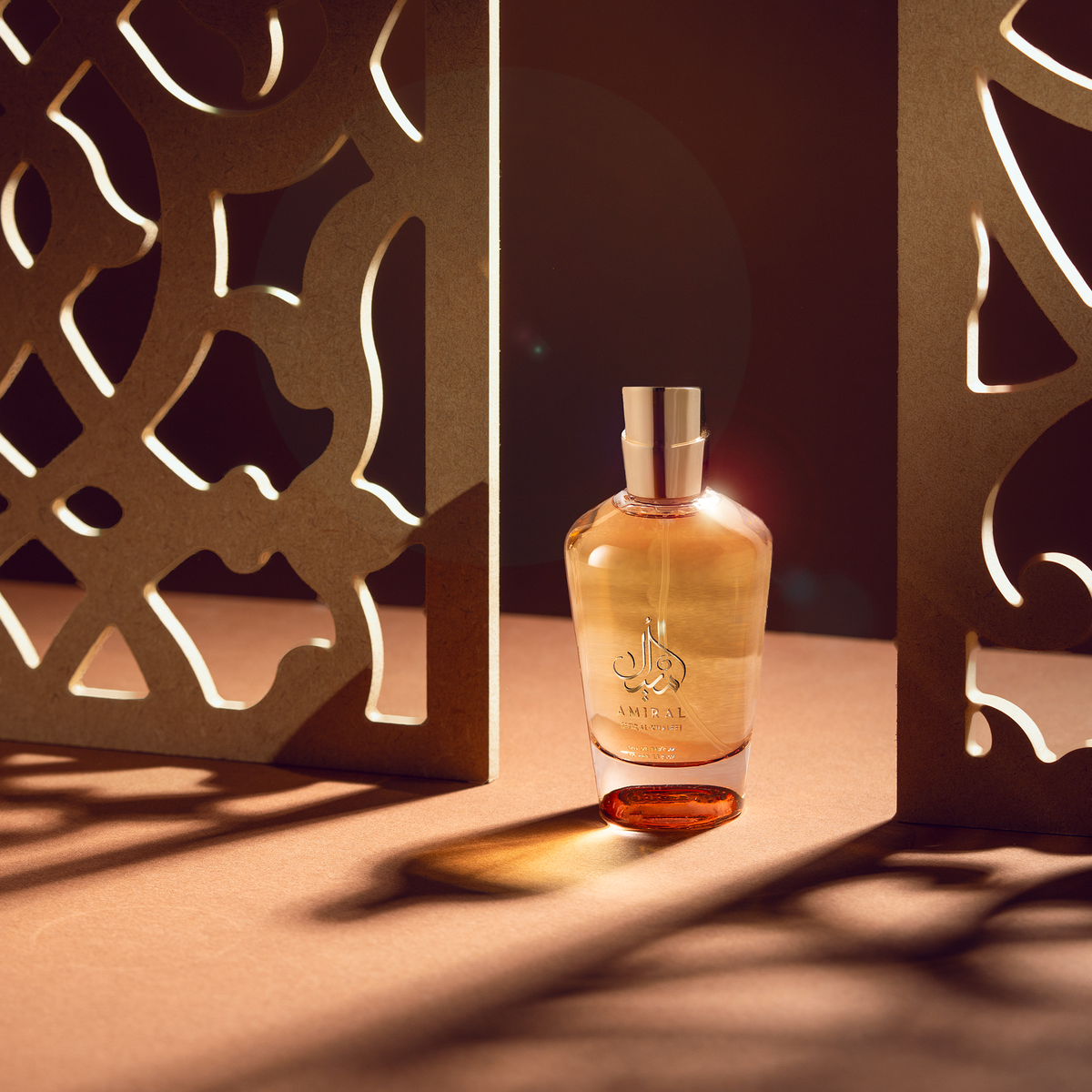 Amiral perfume bottle among mashrabiya pattern shadows