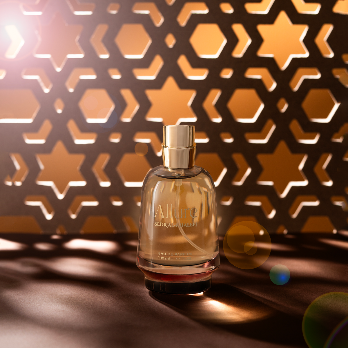 Allure perfume bottle among star-pattern shadows