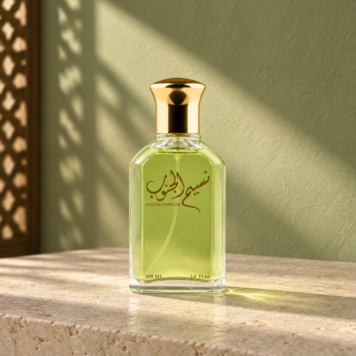 Naseem Aljanob 100 ml perfume bottle with green liquid and a gold cap on limestone in sunlight.