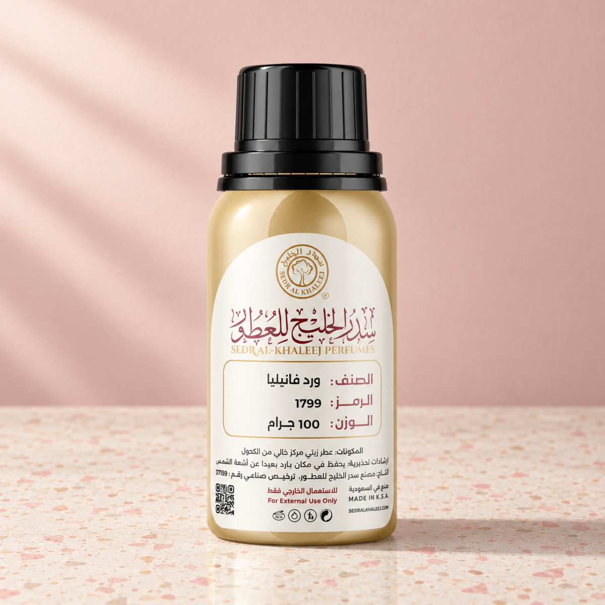 Sedr Al-Khaleej rose vanilla perfume oil; one closed original bottle on cream terrazzo with tiny pink grains before a blush pink, buttercream ivory backdrop.