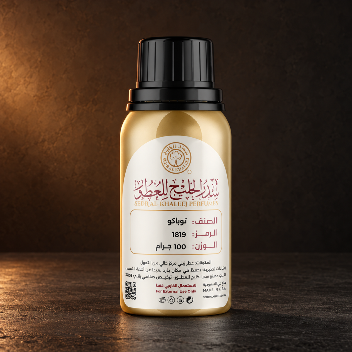 Sedr Al-Khaleej tobacco perfume oil; one closed original bottle on honed charcoal basalt, flat and matte, against deep umber plaster fading gently toward graphite.