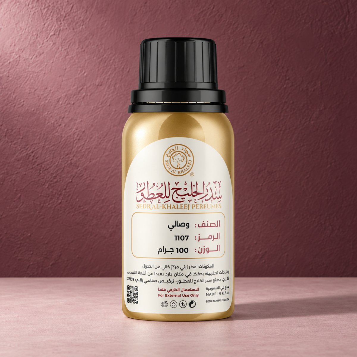 Sedr Al-Khaleej wesal perfume oil; one closed original bottle on pale dusty-rose matte ceramic slab, against muted mulberry plaster wall, saturated but restrained.